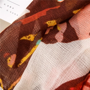 Detail of coffee butterfly print scarf showing semi-transparent cotton-linen texture