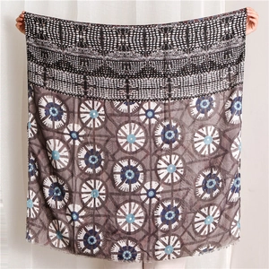 Detail of grey cotton linen scarf with blue and white geometric patterns and tassels