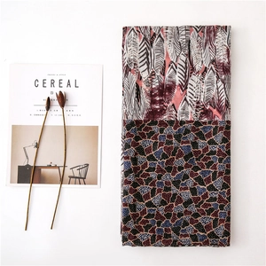 Detail of elegant feather pattern cotton linen shawl scarf with colorful geometric print