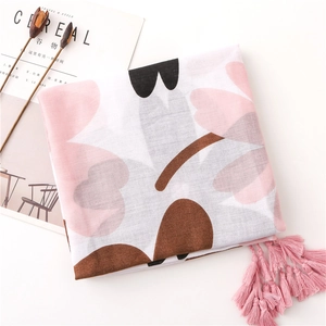 Detailed macro of floral print scarf with pink tassels and breathable cotton linen texture