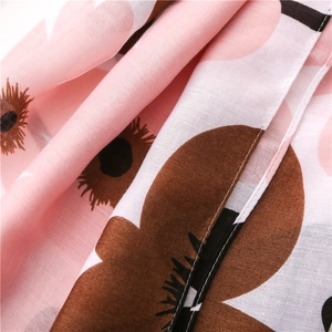 Detail of light pink floral scarf showing premium weave texture and fine edge stitching