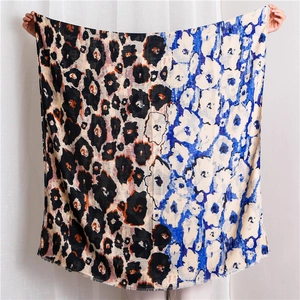 Detail of color-block scarf featuring leopard print, floral patterns and fringed edges