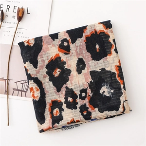 Detail of cotton linen scarf with leopard print patterns and stylish fringe edges