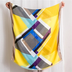 Women's shawl scarf with geometric color block patterns and fringe trim edges