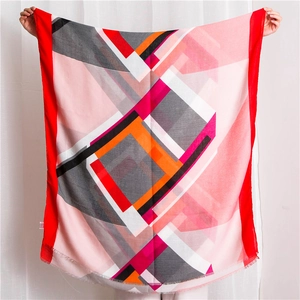 Close-up of geometric print scarf showing soft pink fabric and delicate frayed edges
