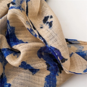 Detailed macro shot of cotton linen scarf texture featuring blue abstract leopard print