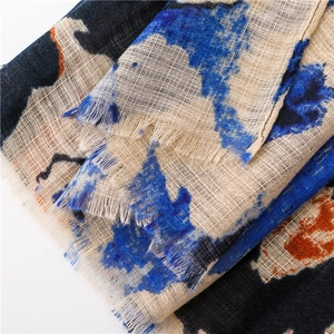 Detailed close-up of cotton linen scarf showing abstract print and fringe texture