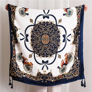Close-up of vintage carriage pattern silk scarf with elegant navy blue tassels