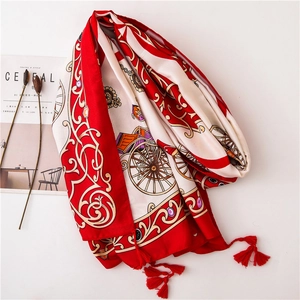 Detail of red and cream silk scarf featuring vintage carriage prints and red tassels