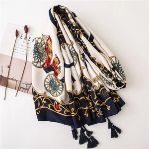 Detail of vintage carriage print scarf with golden baroque motifs and navy tassels