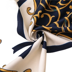 Navy and gold twill scarf featuring a baroque chain pattern and soft luxury texture
