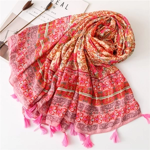 Ethnic cotton linen scarf with vintage floral print and pink tassels on white background
