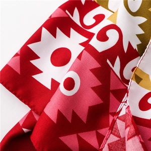 Close-up of ethnic cotton linen scarf showing detailed twill weave and geometric floral pattern