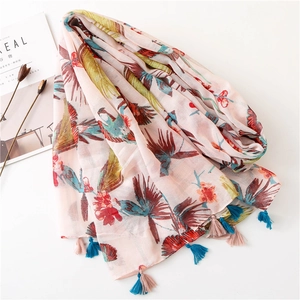 Pink sunscreen shawl with hummingbird floral print and colorful tassels on white background