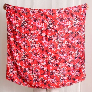 Detail of red floral cotton linen shawl featuring delicate frayed edges and ethnic pattern