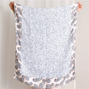 Close-up of soft cotton texture shawl with blue floral and paisley pattern details