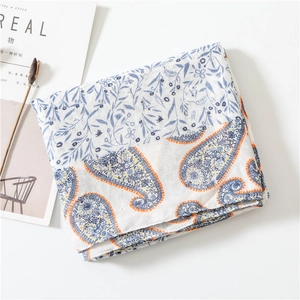 Detail of soft paisley cotton scarf with blue floral prints and artistic props