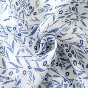 Detail of soft cotton scarf showing blue floral paisley print and linen weave texture