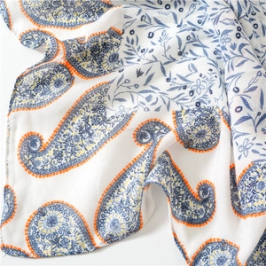 Close-up of lightweight cotton shawl featuring blue and orange paisley floral patterns