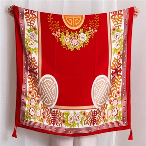 Detail of red Chinese style cotton linen shawl with flower embroidery and tassels