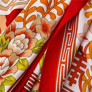 Macro shot of silk twill scarf with peony prints and traditional Double Happiness motifs