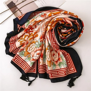 Detailed shot of floral print silk scarf with Chinese peony pattern and black tassels