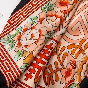 Detail of silk scarf showing traditional Chinese flower patterns and auspicious motifs