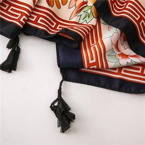 Detail of floral printed cotton linen shawl with retro geometric borders and black tassels