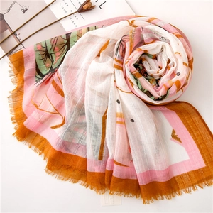 Pink and orange abstract floral scarf with tassels on minimalist white background