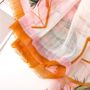 Detailed view of lightweight cactus print scarf with semi-transparent fabric and frayed edges