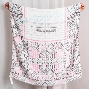 Close-up of cotton linen scarf featuring geometric patterns and fringe edges