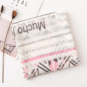 Close-up of cotton linen scarf featuring geometric patterns and Mucho letter print