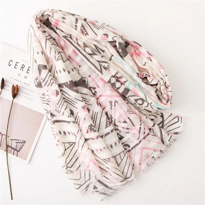 Ivory cotton linen scarf with pastel geometric patterns and fringe edges on white background