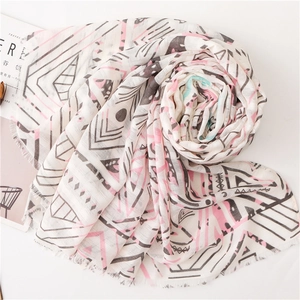 Beige cotton linen scarf with geometric patterns and fringe in an artistic spiral layout