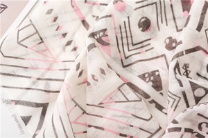 Close-up of cotton linen scarf showing geometric diamond patterns and woven texture