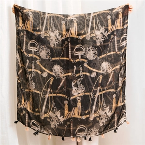 Detail of vintage equestrian print scarf with tassels and retro chain patterns