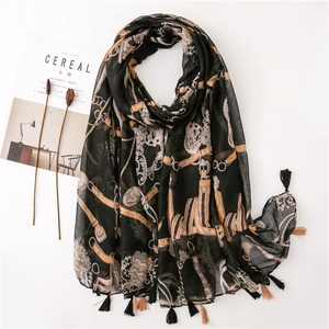 Elegant black printed scarf with vintage gold chain patterns and tassel fringe detail