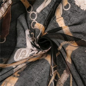 Macro detail of breathable equestrian print scarf with chain and belt patterns