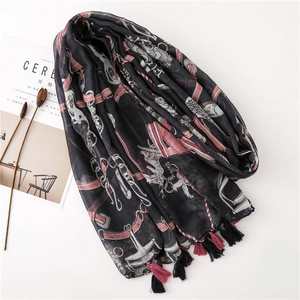 Detail of vintage pattern print scarf with decorative fringes and light fabric texture