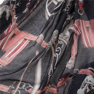 Macro detail of lightweight floral scarf with equestrian horse and buckle print pattern