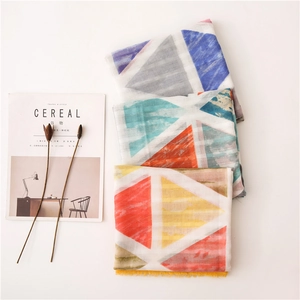 Three cotton linen scarves featuring geometric patchwork patterns and fringe details