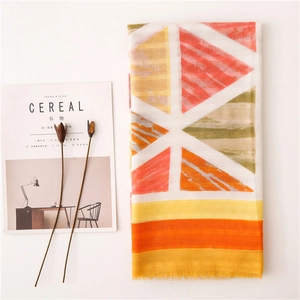 Detailed view of colorful geometric cotton linen scarf with soft fringe and Nordic decor