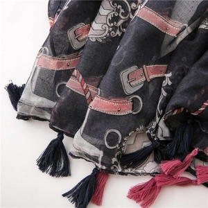 Detailed close-up of retro printed scarf with elegant double-colored fringe tassels