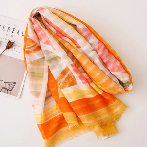 Detailed close-up of colorful geometric cotton linen scarf with soft fringe trim details