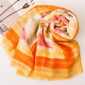 Detail of warm yellow and orange striped cotton linen scarf with soft frayed edges