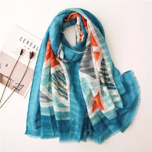 Macro detail of royal blue linen shawl featuring abstract geometric prints and raw edges