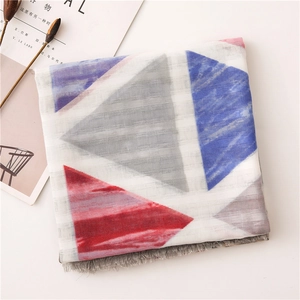 Detail of cotton linen scarf with geometric triangle patterns and grey fringe edge