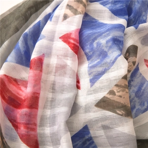 Close-up of geometric cotton linen scarf showing woven mesh texture and vibrant colors