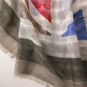 Detail of cotton linen scarf showing geometric patterns and delicate fringe texture