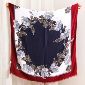 Detail of floral printed linen scarf featuring vintage patterns and fine fringe edges